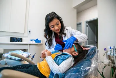 Dr. Pathiyil providing dental care for a young patient at Sunnyvale Kids Pediatric Dentistry