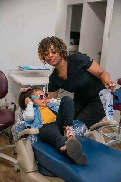 Dental assistant LaTonya helping a pediatric patient at Sunnyvale Kids Pediatric Dentistry