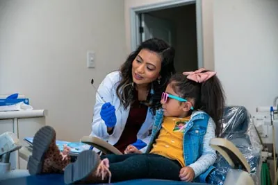 Dr. Pathiyil talking with one of her pediatric dental patients at Sunnyvale Kids Pediatric Dentistry