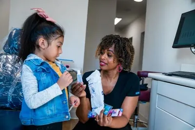 pediatric patient receiving her goody bag after getting dental care at Sunnyvale Kids Pediatric Dentistry